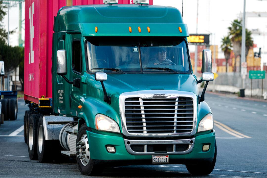 A truck drives through the Port of Oakland in Oakland, Calif., on Nov. 14, 2025. California has revoked 17,000 commercial driver’s licenses improperly issued to foreign drivers, about 2.5 percent of all commercial licenses in the state. (Justin Sullivan/Getty Images)