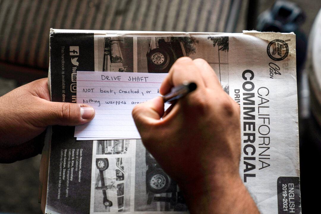 A student truck driver makes flash cards for his commercial driver’s license exam while taking a class in California on Nov. 15, 2021. (Jae C. Hong/File/AP Photo)
