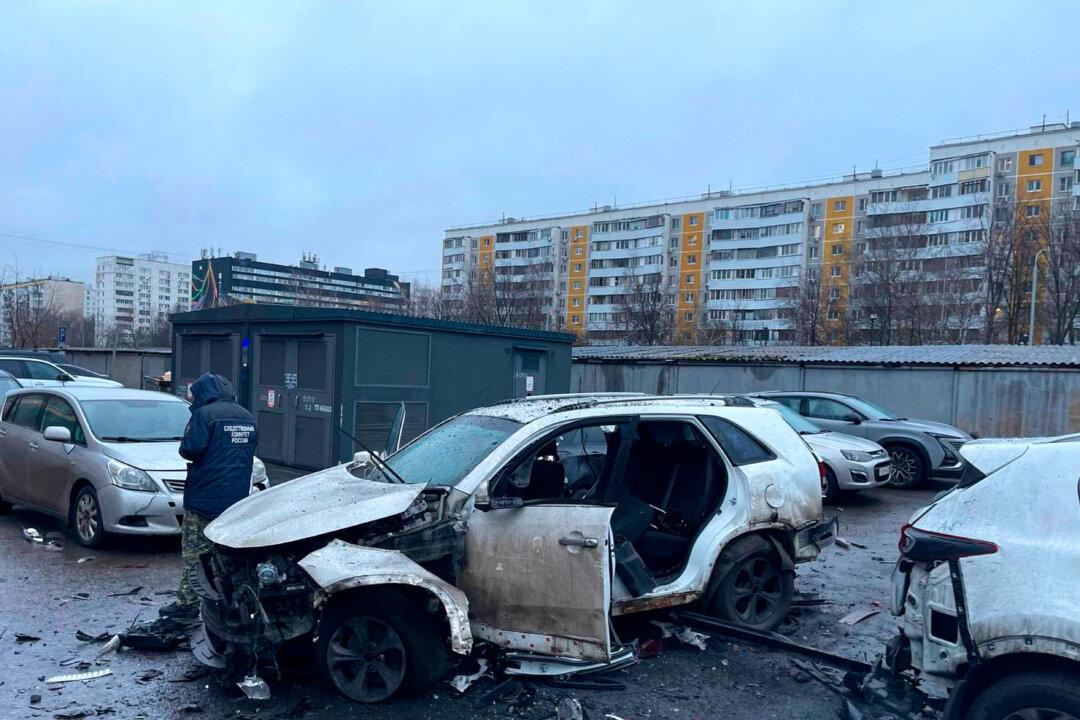 An investigator working at the scene where Lt. Gen. Fanil Sarvarov, head of the Operational Training Directorate of the Russian Armed Forces General Staff, was killed by an explosive device placed under his car, in Moscow on Dec. 22, 2025. (Investigative Committee of Moscow via AP)