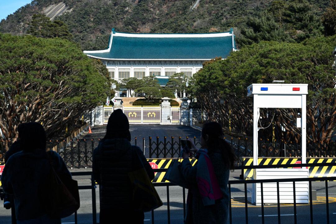Tourists take pictures in front of the Blue House, known as Cheong Wa Dae in Korean, in Seoul, South Korea, on Dec. 22, 2025. South Korea's president and his team have started moving back into Seoul's historic Blue House, and the process will be wrapped up by Christmas, an official said on Dec. 9. (Jung Yeon-je/AFP via Getty Images)