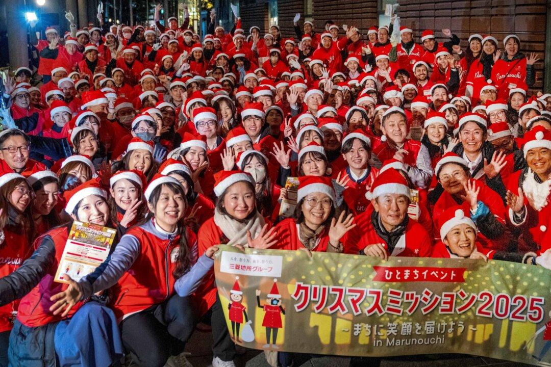 Office workers dressed as Santa Claus participate in Christmas Mission 2025, an event to liven up the area during the festive season, in Tokyo's Marunouchi business district on Dec. 22, 2025. (Kazuhiro Nogi/AFP via Getty Images)