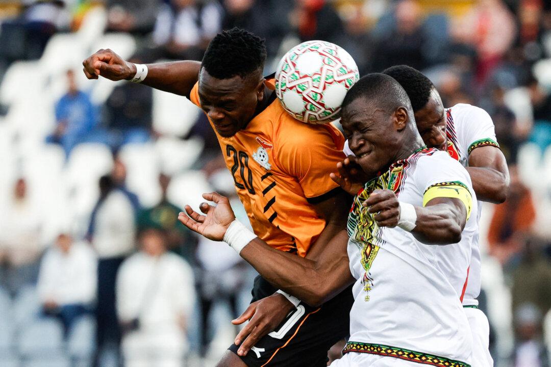 Zambia's midfielder David Simukonda (R) fights for the ball with Mali's midfielder Aliou Dieng (2nd R) during an Africa Cup of Nations Group A match at Mohammed V Stadium in Casablanca, Morocco, on Dec. 22, 2025. (Abdel Majid Bziouat/AFP via Getty Images)