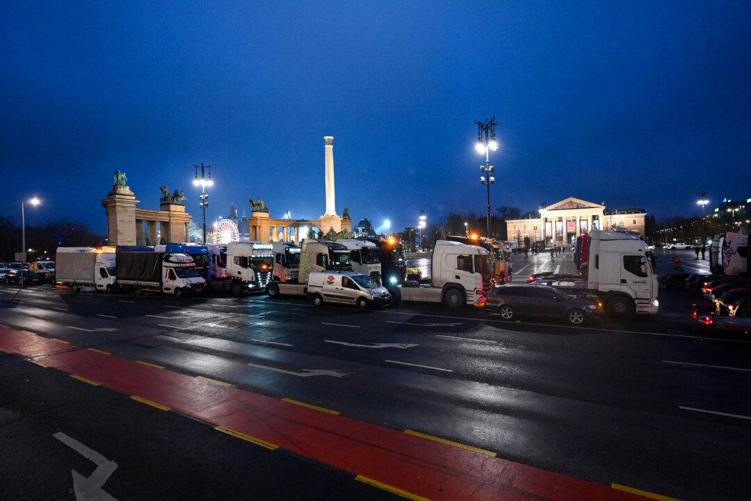 Trucks, vans and other vehicles block Heroes' Square in Budapest, Hungary, on Dec. 22, 2025, as drivers stage a traffic-slowing protest against planned toll hikes. Under the government proposal, motorway fees would rise 4.3 percent in line with inflation, while charges for trucks on main roads could jump by more than 50 percent. (Attila Kisbenedek/AFP via Getty Images)
