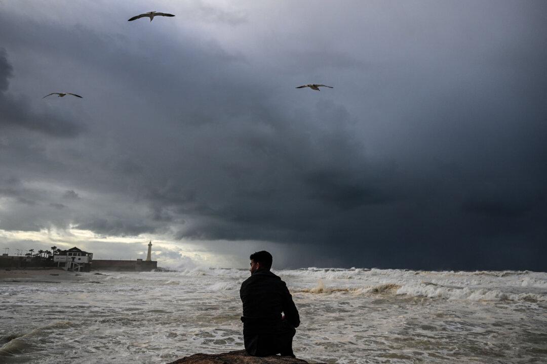 A man sits on a rock overlooking the ocean in Rabat, Morocco, on Dec. 22, 2025, during the Africa Cup of Nations football tournament. (Gabriel Bouys/AFP via Getty Images)
