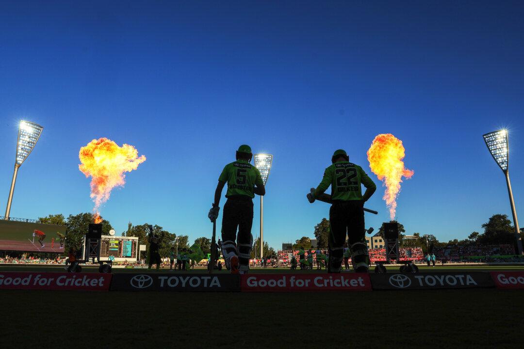 Sam Konstas and Matthew Gilkes of the Sydney Thunder run out to bat during the Big Bash League cricket match against the Brisbane Heat at Manuka Oval in Canberra, Australia, on Dec. 22, 2025. (Mark Metcalfe/Getty Images)