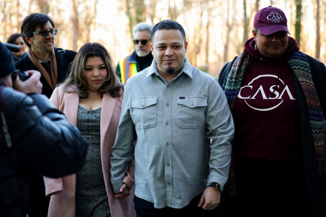 Kilmar Abrego Garcia arrives with his wife, Jennifer Vasquez Sura, and attorney Simon Sandoval-Moshenberg (L) at U.S. District Court in Greenbelt, Md., on Dec. 22, 2025. Abrego Garcia, a longtime Maryland resident who was deported to the high-security CECOT prison in El Salvador, then sent back to the United States and released after the court found his detention unlawful, attended a hearing on whether Immigration and Customs Enforcement may re-detain him. (Alex Wong/Getty Images)