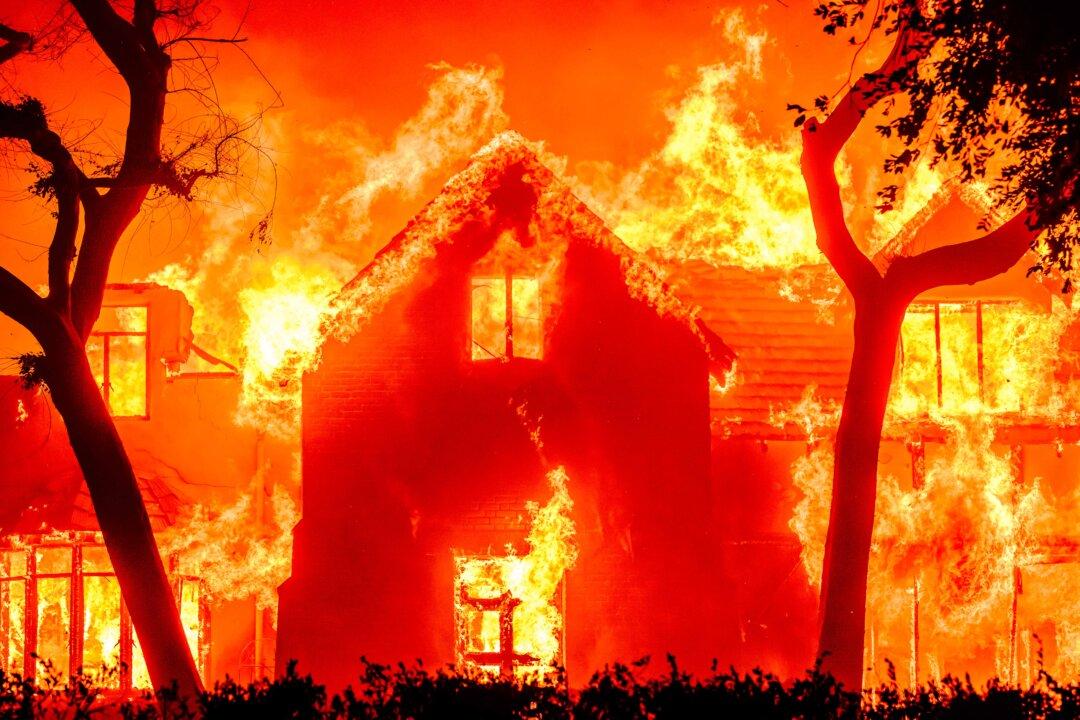 A home is engulfed in flames during the Eaton fire in the Altadena area of Los Angeles County, Calif., on Jan. 8, 2025. A ferocious wildfire in a Los Angeles suburb devoured buildings and sparked panicked evacuations, as hurricane-force winds tore through the region. More than 200 acres was burning in Pacific Palisades, a upscale spot with multi-million dollar homes in the Santa Monica Mountains. Across town, on the northern edge of Los Angeles, another fire broke out in Eaton Canyon, near Pasadena, quickly consuming 200 acres later in the night, according to National Forest officials. (Josh Edelson/AFP via Getty Images)