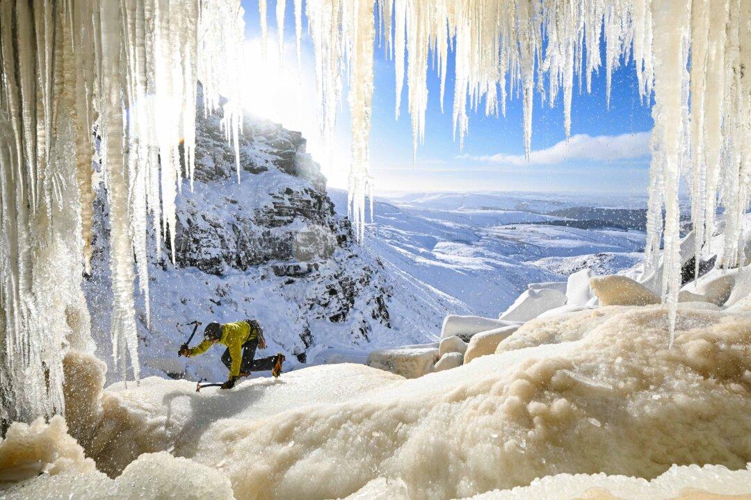 An ice climber ascends Kinder Downfall, a frozen waterfall in the Peak District National Park, near Hayfield, in northwest England, on Jan. 10, 2025. (Oli Scarff/AFP via Getty Images)