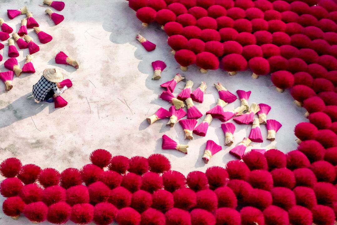 A worker arranges incense sticks to dry in a courtyard in Quang Phu Cau village on the outskirts of Hanoi, Vietnam, on Jan. 21, 2025. (Nhac Nguyen/AFP via Getty Images)