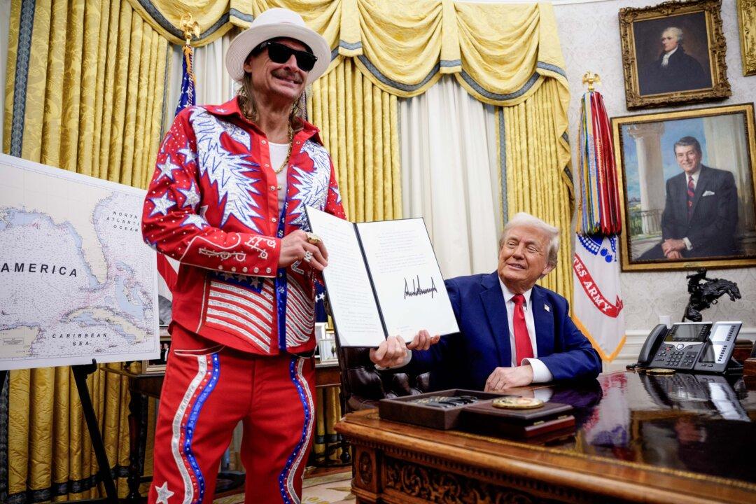 President Donald Trump, accompanied by entertainer Kid Rock, signs an executive order against ticket scalping and to reform the live entertainment ticket industry, in the Oval Office on March 31, 2025. (Andrew Harnik/Getty Images)