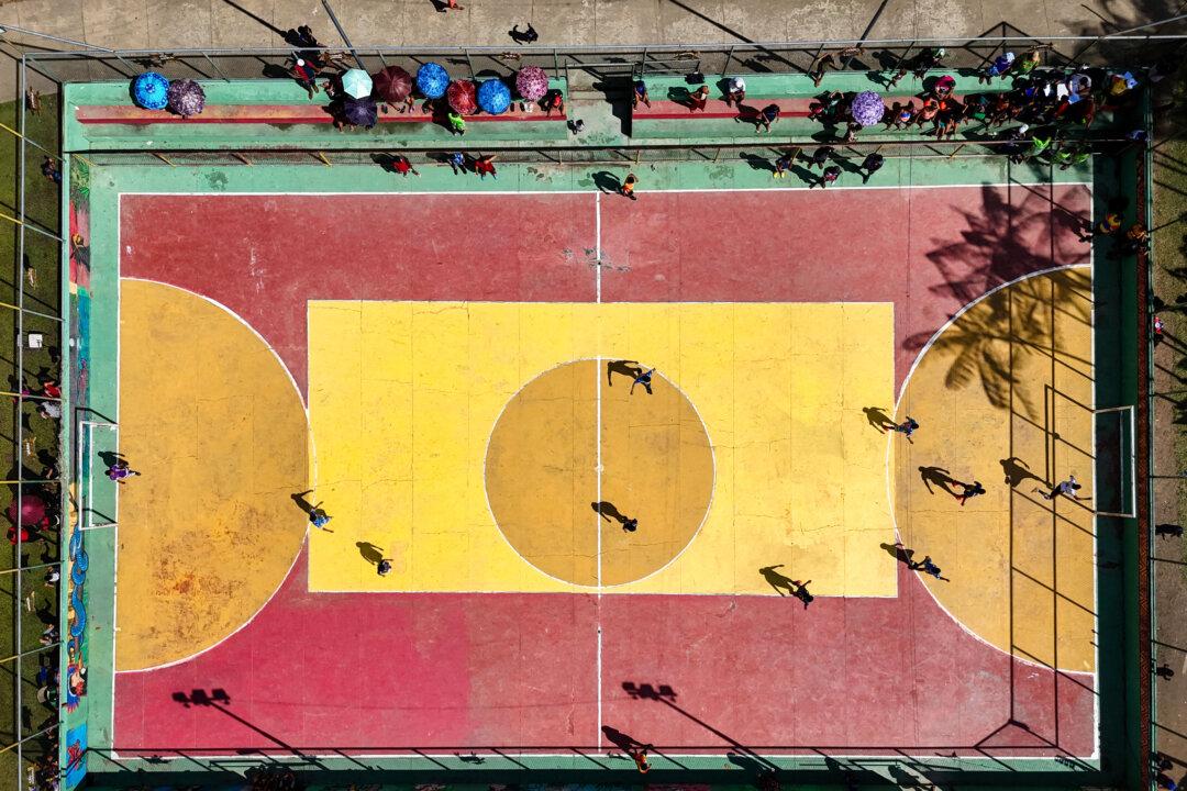 An aerial view shows a futsal match during the Alvaraes Indigenous Intercultural Games and Dances at the Marajai Village in Alvaraes, Amazonas State, northern Brazil, on April 16, 2025. With the slogan “Protecting Mother Earth,” the third edition of the event will feature the participation of 16 people from the region and will focus on the importance of demarcating indigenous lands, preserving nature and natural resources, and highlighting the importance of rescuing and preserving indigenous culture, keeping these traditions alive for future generations. (Michael Dantas/AFP via Getty Images)