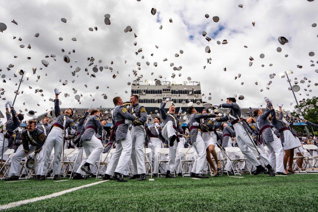 U.S. Military Academy cadets throw their hats at the 2025 graduation ceremony at the United States Military Academy at West Point on May 24, 2025. (Samira Bouaou/The Epoch Times)