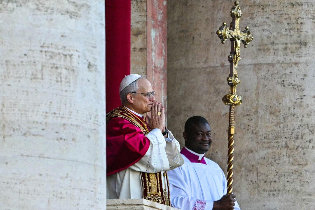Newly elected Pope Leo XIV (L) gestures as he addresses the crowd from the main central loggia balcony of St Peter's Basilica for the first time, after the cardinals ended the conclave, in The Vatican, on May 8, 2025. Robert Francis Prevost is the first pope from the United States. He spent years as a missionary in Peru, and he becomes the Catholic Church's 267th pontiff, taking the papal name Leo XIV. (Andrej Isakovic/AFP via Getty Images)