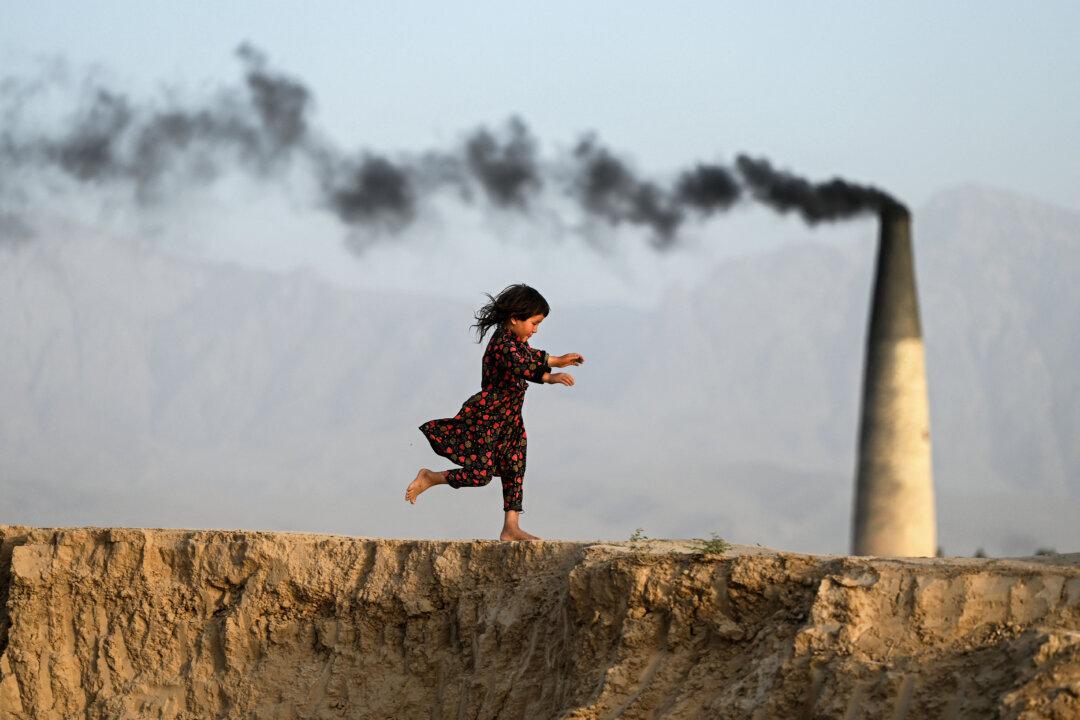 An Afghan girl runs across a brick kiln on the outskirts of Mazar-i-Sharif, Afghanistan, on June 22, 2025. (Wakil Kohsar/AFP via Getty Images)