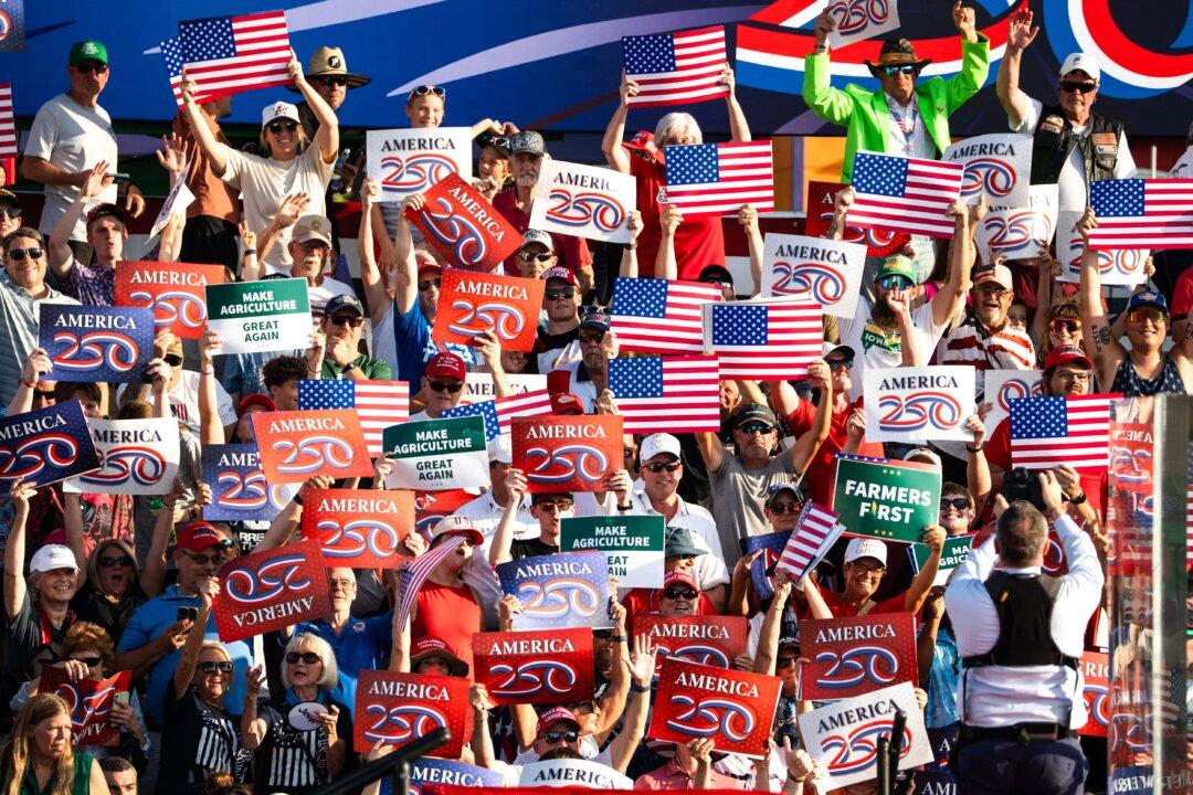 People wait at the Iowa State Fairgrounds ahead of President Donald Trumpís remarks marking the beginning of a year of festivities before the 250th anniversary of the signing of the Declaration of Independence, in Des Moines, Iowa, on July 3, 2025. (Madalina Kilroy/The Epoch Times)