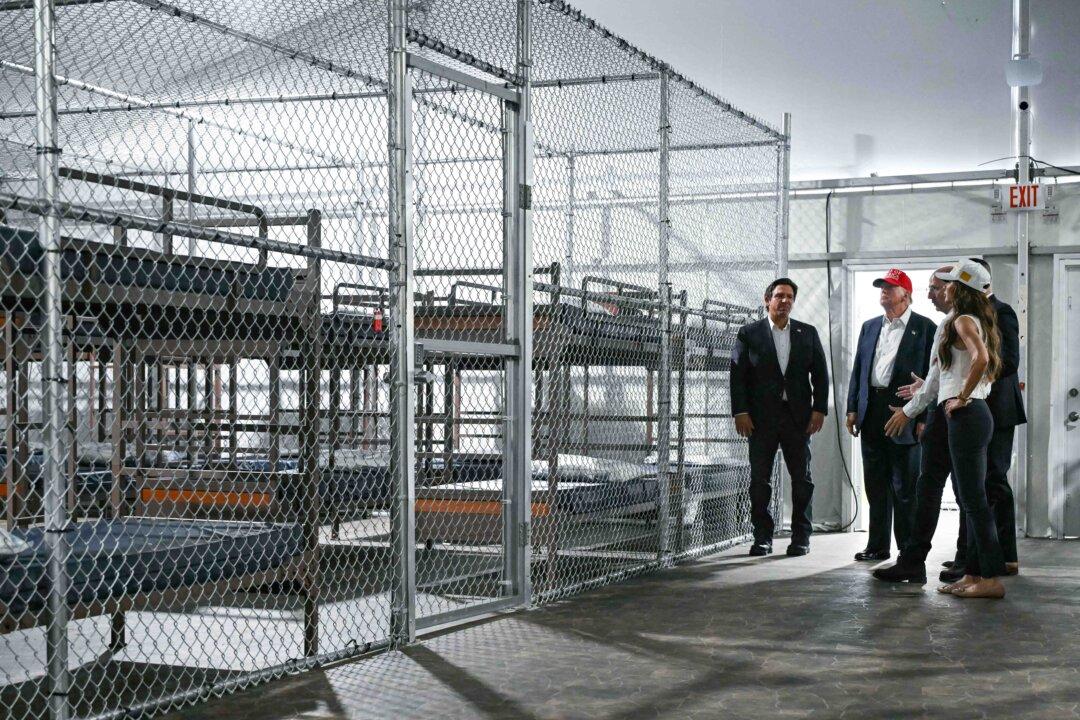 President Donald Trump (2L), Florida Gov. Ron DeSantis (L), and Secretary of Homeland Security Kristi Noem (R) tour an immigration detention center, dubbed Alligator Alcatraz, located at the site of the Dade-Collier Training and Transition Airport in Ochopee, Fla., on July 1, 2025. (Andrew Caballero-Reynolds/AFP via Getty Images)
