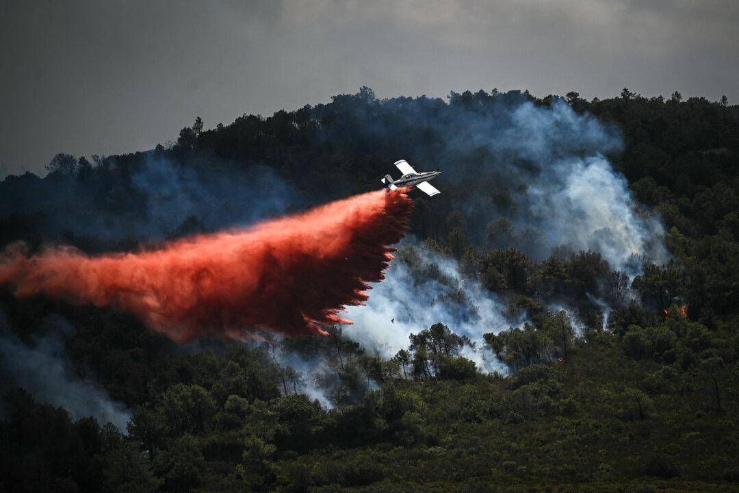 Fire-fighting aircraft Air Tractor AT-802 drops fire retardant over a wildfire near the Aussieres neighbourhood, close to the city of Narbonne in southwestern France, on July 8, 2025. (Matthieu Rondel/AFP via Getty Images)