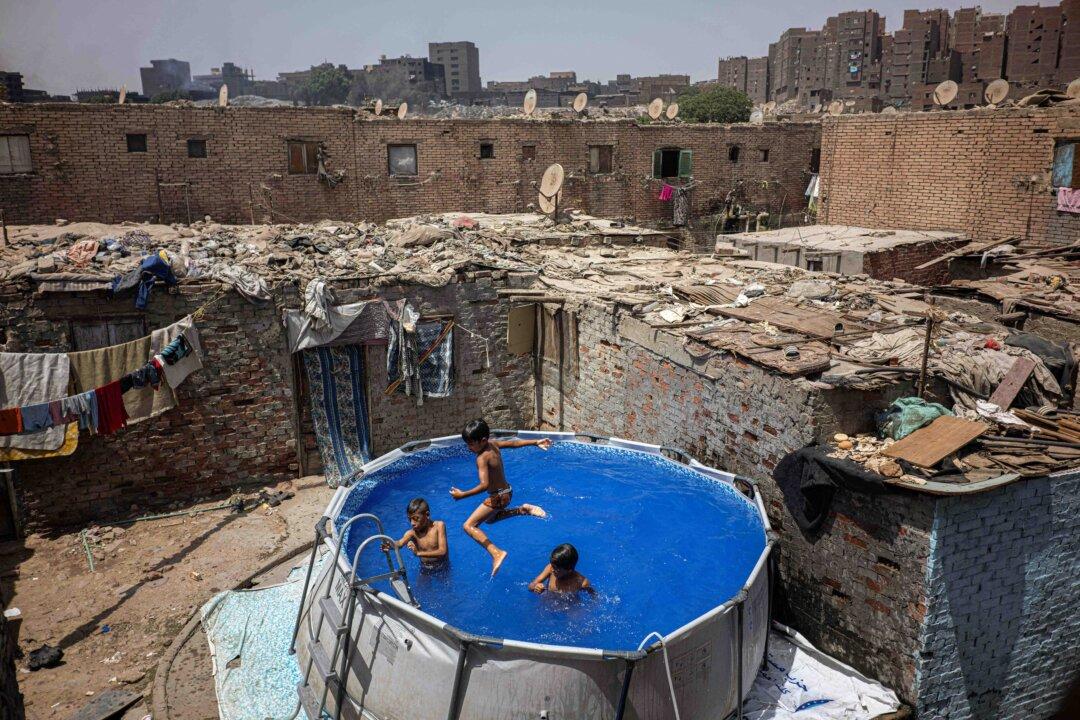 Boys cool down in a portable swimming pool in the al-Duwaiqa neighborhood of Cairo, Egypt, on July 29, 2025. (Khaled Desouki/AFP via Getty Images)