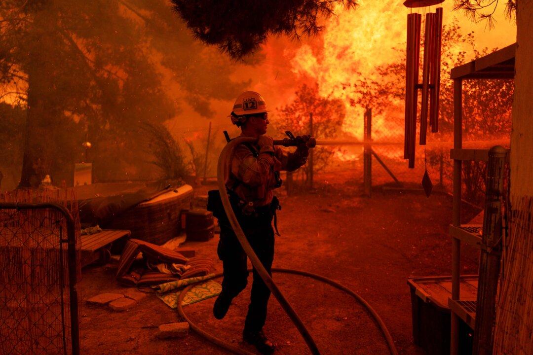 A firefighter battles flames from the Canyon Fire in Castaic, Calif., on Aug. 7, 2025. Evacuation warnings were issued from the Los Angeles County line to the northwest of Lake Piru. According to the National Weather Service, temperatures in the area reached between 90 degrees F to 100 degrees F with 15 percent to 20 percent humidity. (Eric Thayer/Getty Images)