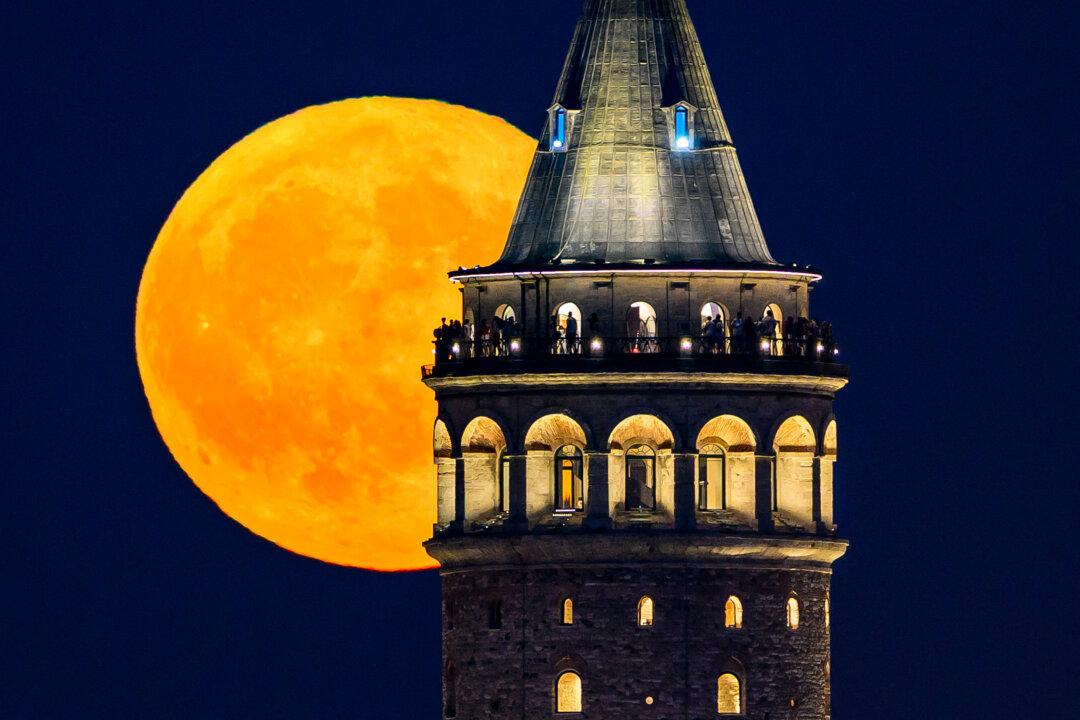 The Sturgeon moon is seen rising over Galata Tower in Istanbul on Aug. 9, 2025. (Asin Akgul/AFP via Getty Images)