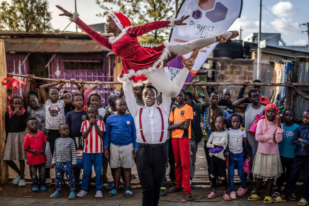 Ballet student and main lead Shelly Ajiambo strikes a pose while being supported by main male lead Dustine Okinyi as they dance onstage during Project Elimu's annual Christmas ballet performance in the Kibera settlement of Nairobi, Kenya, on Dec. 23, 2025. At Project Elimu's Kibera Ballet School, young dancers engage with classical ballet as part of a community-led arts program that fosters discipline, creativity, and confidence. (Luis Tato/AFP via Getty Images)