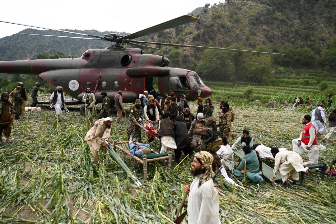 Afghan volunteers and Taliban security personnel work to move injured people near a military helicopter following earthquakes in the Mazar Dara village of Nurgal, a district of the Kunar Province, in eastern Afghanistan on Sept. 1, 2025. More than 2,000 people were killed and more than 3,500 were injured after the magnitude 6 earthquake, which was followed by at least five aftershocks felt hundreds of miles away. (Wakil Kohsar/AFP via Getty Images)