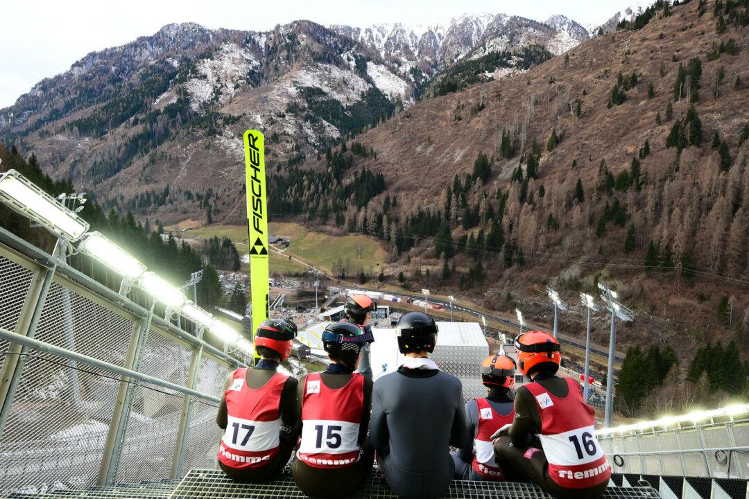 Athletes take part in a training session at the Ski Jumping arena prior the Open Italian Championship of ski jumping in Predazzo, on Dec. 23, 2025. The arena in Predazzo will host the ski jumping and Nordic combined competitions, during the Milano Cortina 2026 Winter Olympics. (Stefano Rellandini/AFP via Getty Images)