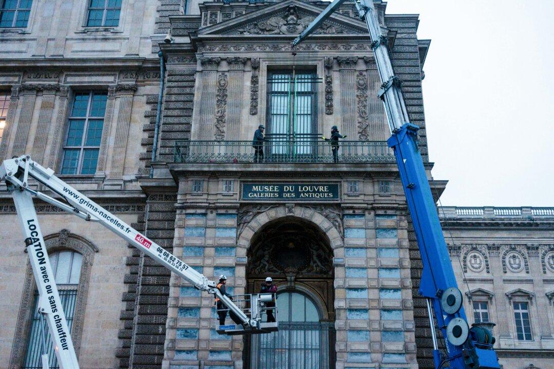 Workers install iron window guards at the Gallerie d'Apollon (Apollo's gallery) of the Louvre Museum in Paris on Dec. 23, 2025, a few weeks after thieves used a furniture lift to break into the museum. (Dimitar Dilkoff/AFP via Getty Images)