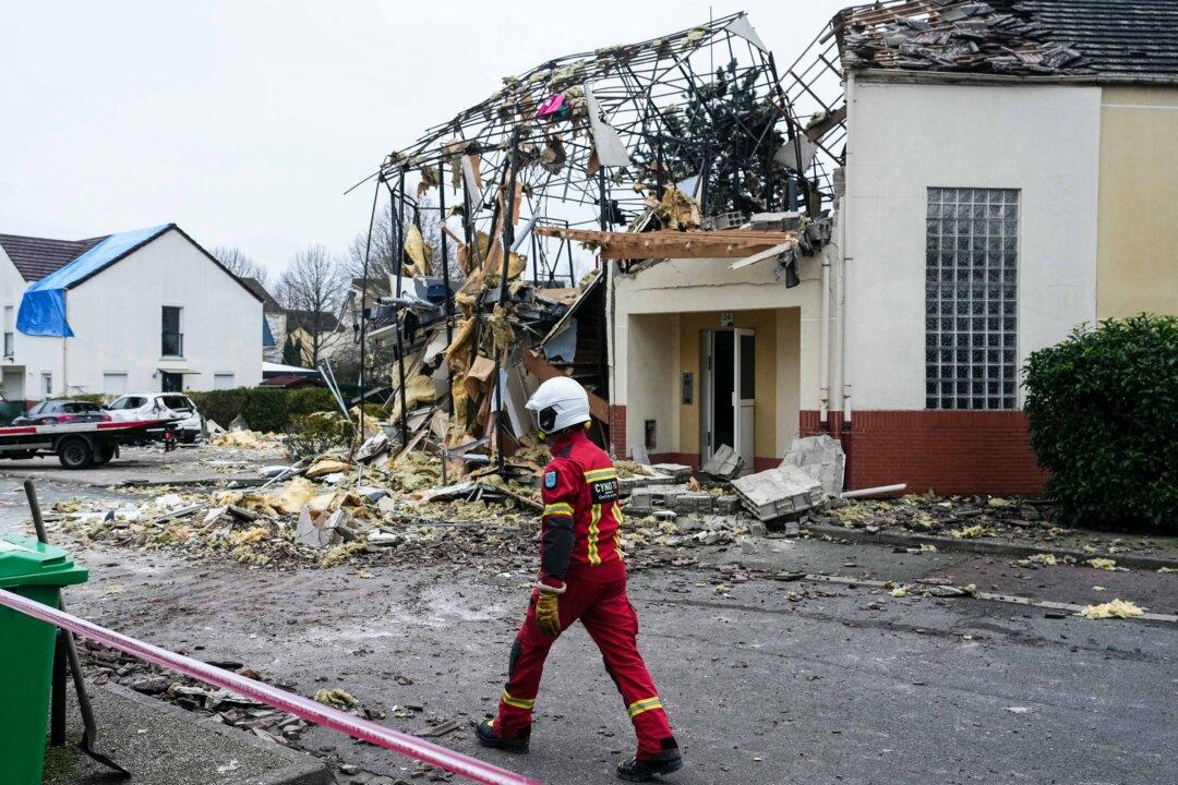 A firefighter walks past a destroyed house in Magny-les-Hameaux in southwestern Paris on Dec. 23, 2025, following an explosion that left four people seriously injured, including three children ages 2 to 5, the Yvelines prefecture told AFP. (Dimitar Dilkoff/AFP via Getty Images)