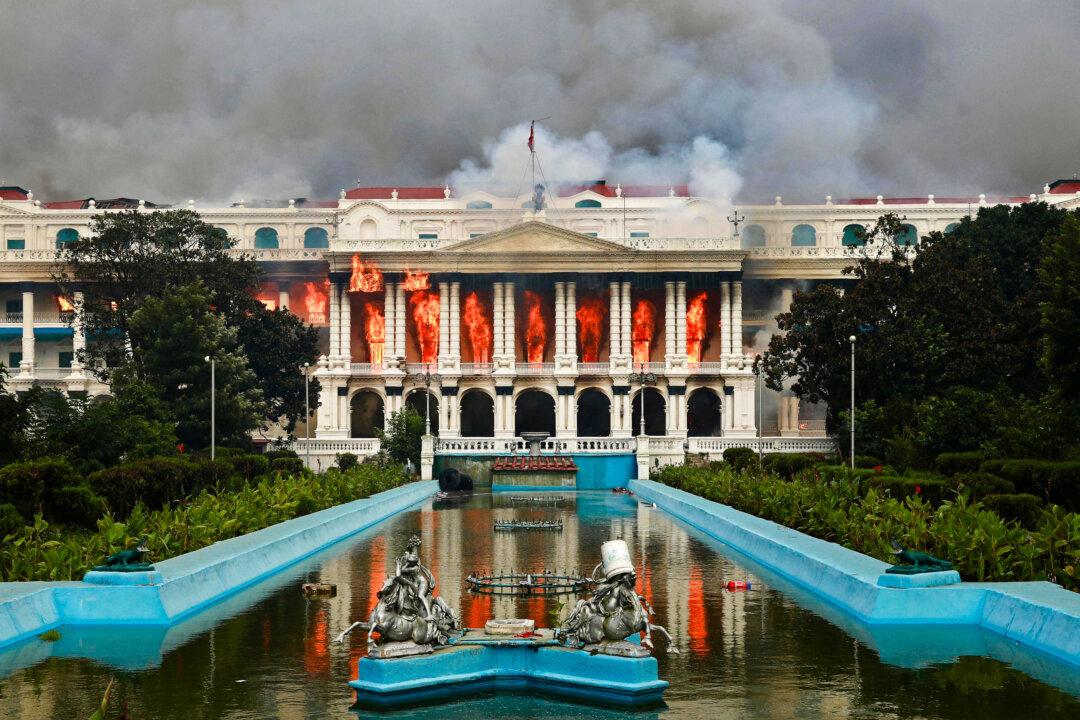 Nepali youth protesters set fire to the Singha Durbar, the main administrative building for the Nepal government, as the veteran prime minister obeyed furious crowds to quit, in Kathmandu, Nepal, on Sept. 9, 2025. The day prior, police cracked down on demonstrations over social media prohibitions and government corruption and at least 19 people were killed. (Prabin Ranabhat/AFP via Getty Images)