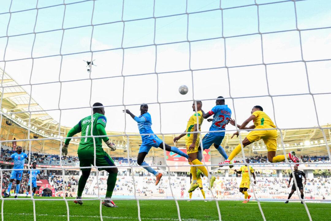 Democratic Republic of Congo's defender Axel Tuanzebe (4), Benin's defender Olivier Verdon (6), and Democratic Republic of Congo defender Chancel Mbemba (22) vie for the ball during the Africa Cup of Nations Group D match at Al Medina Stadium in Rabat, Morocco, on Dec. 23, 2025. (Sebastien Bozon/AFP via Getty Images)