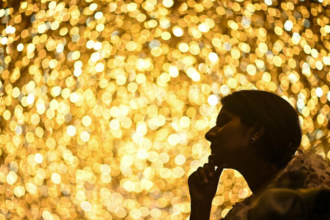 A woman looks on at the Phoenix Mall of Asia decorated with lighting ahead of Christmas in Bengaluru, India, on Dec. 23, 2025. (Idrees Mohammed/AFP via Getty Images)