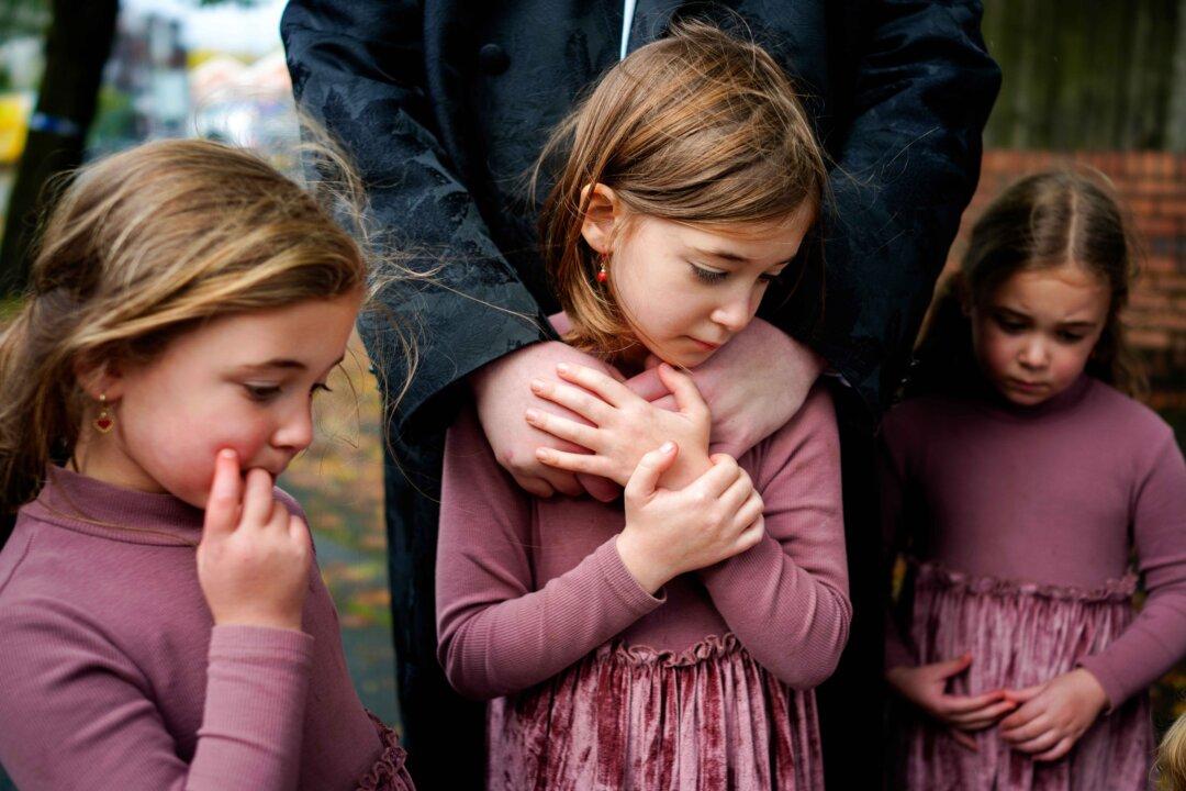 Local family members pay their respects and view floral tributes at the scene of a terror attack at the Heaton Park Hebrew Congregation Synagogue in Manchester, England, on Oct. 4, 2025. On the morning of Oct. 2, a stabbing and car attack on the synagogue left two people dead and four others hospitalized. The attack took place on Yom Kippur, the holiest day of the Jewish calendar, and was declared a terrorist incident by police. The suspected attacker was fatally shot by police at the scene. (Christopher Furlong/Getty Images)