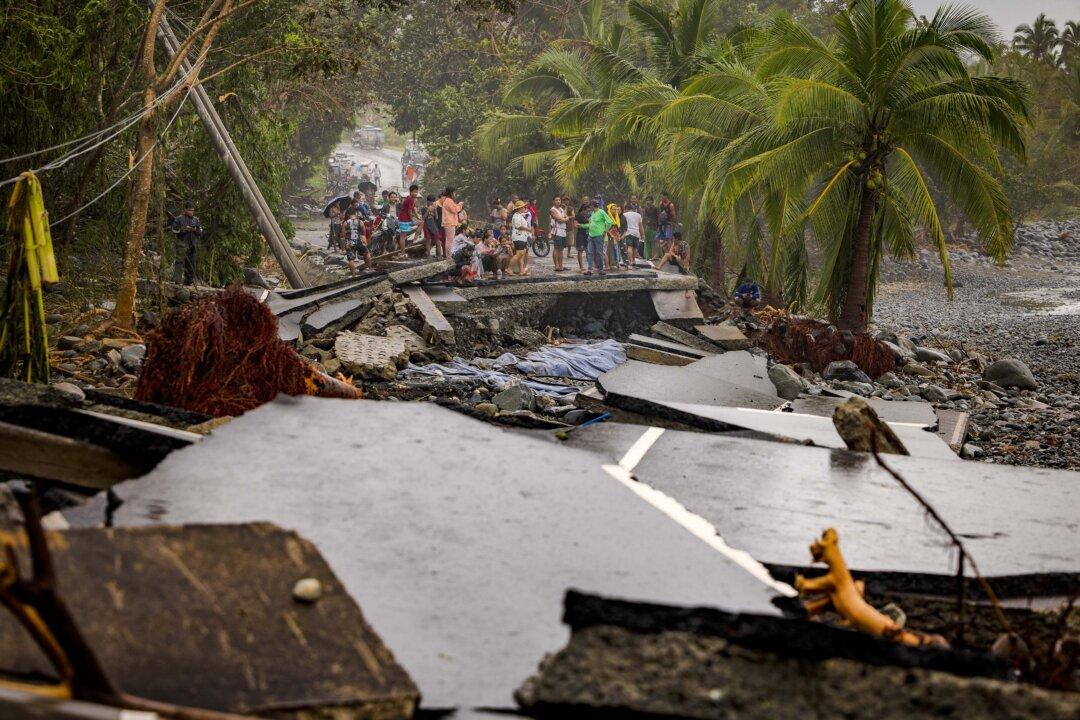 Residents survey a highway destroyed by storm surges brought about by Super Typhoon Fung-wong in Dipaculao, Aurora province, Philippines, on Nov. 10, 2025. (Ezra Acayan/Getty Images)
