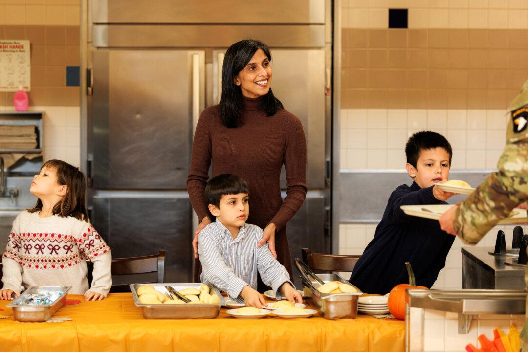 Second Lady Usha Vance and her children serve members of the 101st Airborne Division in Fort Campbell, Tenn., on Nov. 26, 2025. Vice President JD Vance made the trip to Fort Campbell with his family to serve an early Thanksgiving meal to service members. (Brett Carlsen/Getty Images)