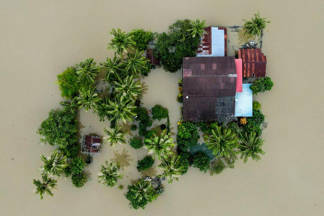 An aerial view shows a home surrounded by flood waters in Kangar in northern MalaysiaÕs Perlis state on Nov. 28, 2025. Severe flooding affected thousands of people in the region following days of heavy rain. The annual monsoon season, exacerbated by a tropical storm, inundated parts of southern Thailand, killing dozens and trapping many in their homes. In Malaysia, it also brought heavy flooding and killed at least two people. (Mohd Rasfan/AFP via Getty Images)