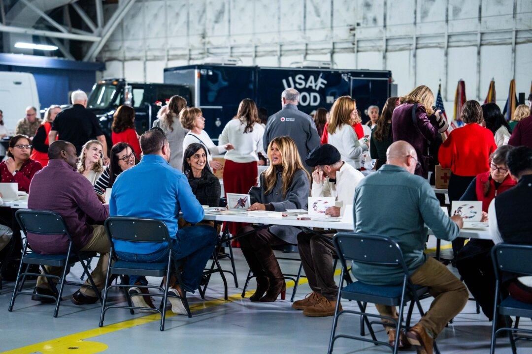 First Lady Melania Trump speaks with guests during a Red Cross holiday care package building and card-writing event at Joint Base Andrews, Md., on Dec. 1, 2025. (Madalina Kilroy/The Epoch Times)
