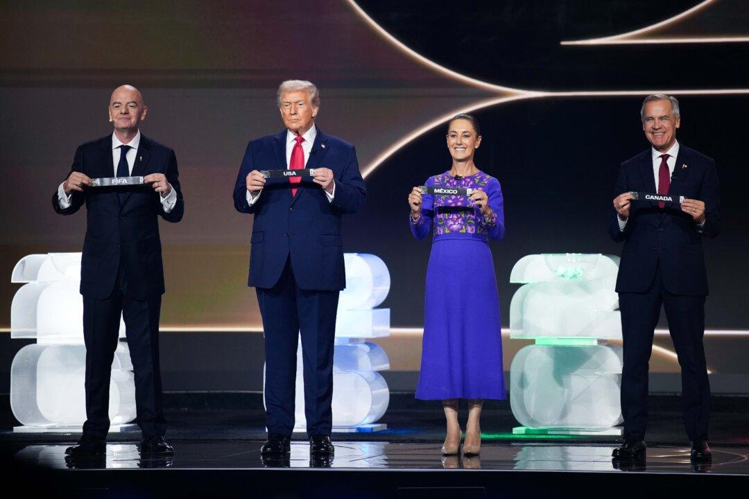 (L-R) FIFA President Gianni Infantino, U.S. President Donald Trump, Mexican President Claudia Sheinbaum, and Canadian Prime Minister Mark Carney participate in the FIFA World Cup 2026 Official Draw at the John F. Kennedy Center for the Performing Arts in Washington on Dec. 5, 2025. The 2026 FIFA World Cup will take place between June 11, 2026, and July 19, 2026, featuring 48 teams with matches being played in the United States, Mexico, and CanadaÑthe first time the international sporting event will be hosted by three nations. (Andrew Harnik/Getty Images)