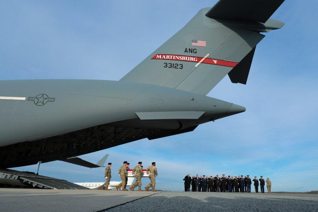 A U.S. Army carry team moves a flagged-draped transfer case containing the remains of Iowa National Guardsman Sgt. William Nathaniel Howard at Dover Air Force Base in Dover, Del., on Dec. 17, 2025. Iowa National Guard members Sgt. William Nathaniel Howard and Sgt. Edgar Brian Torres-Tovar, and Ayad Mansoor Sakat, a U.S. civilian working as an interpreter, were killed during a recent ambush by a member of the ISIS terrorist group in Syria. (Anna Moneymaker/Getty Images)