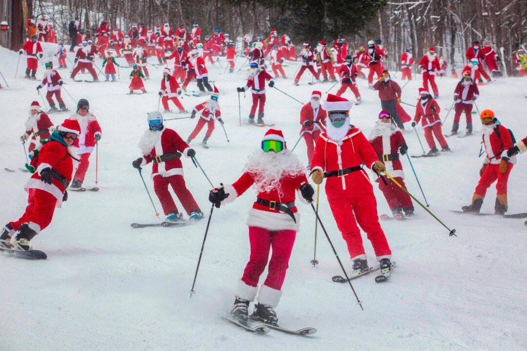 People dressed in Santa Claus costumes ski down South Ridge at the Sunday River resort in Newry, Maine, on Dec. 14, 2025, to raise money for The River Fund and the Boyne Forever Foundation. (Lauren Owens Lambert/AFP via Getty Images)