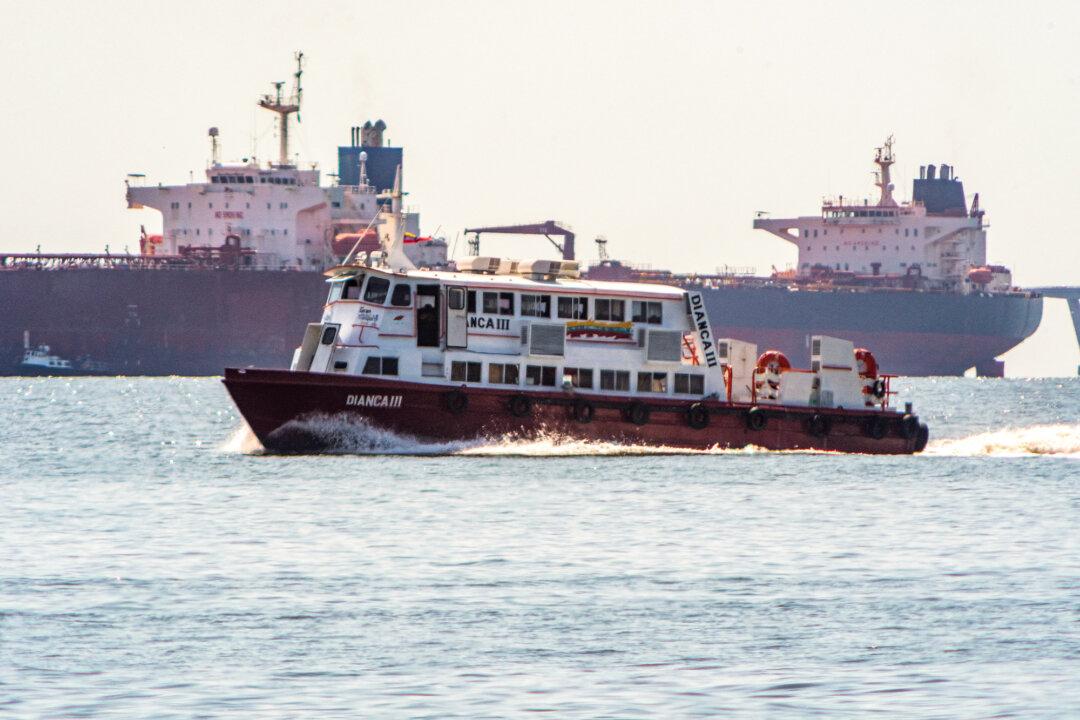A boat passes by a crude oil tanker anchored on Lake Maracaibo near Maracaibo, Venezuela, on Dec. 18, 2025. (Alejandro Paredes / AFP via Getty Images)
