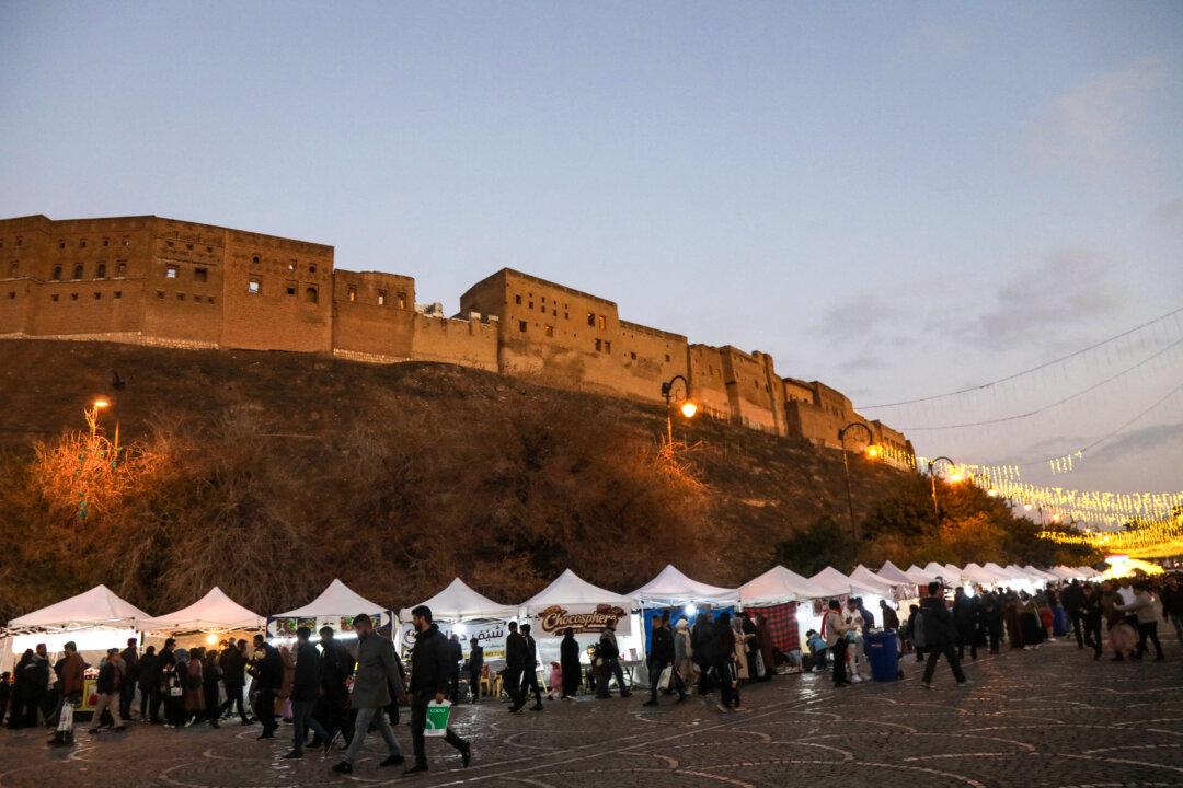 Iraqis visit a Christmas market set up at the foot of the city's ancient Citadel in Arbil, the capital of Iraqi's northern autonomous Kurdish region, on Dec. 24, 2025. (Safin Hamid/AFP via Getty Images)