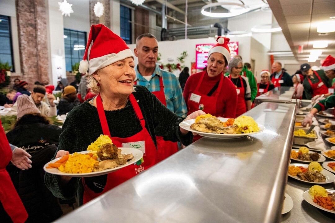 Volunteers serve meals to guests at the St. Francis House, New England's largest day shelter, on Christmas Day in Boston, Mass., on Dec. 25, 2025. According to a 2025 census done by the city of Boston, there are 2,122 single adults who experienced homelessness in the city. (Joseph Prezioso/AFP via Getty Images)
