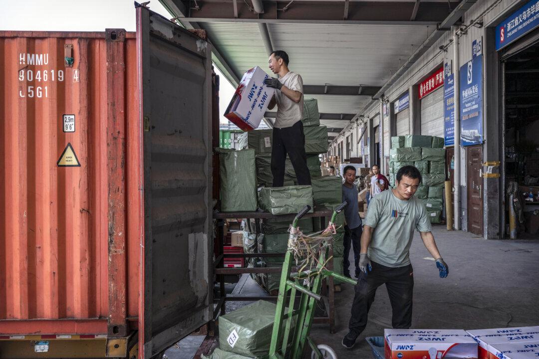 Workers load goods for export into a container at a logistics hub in Yiwu, Zhejiang Province, China, on April 29, 2025. (Kevin Frayer/Getty Images)