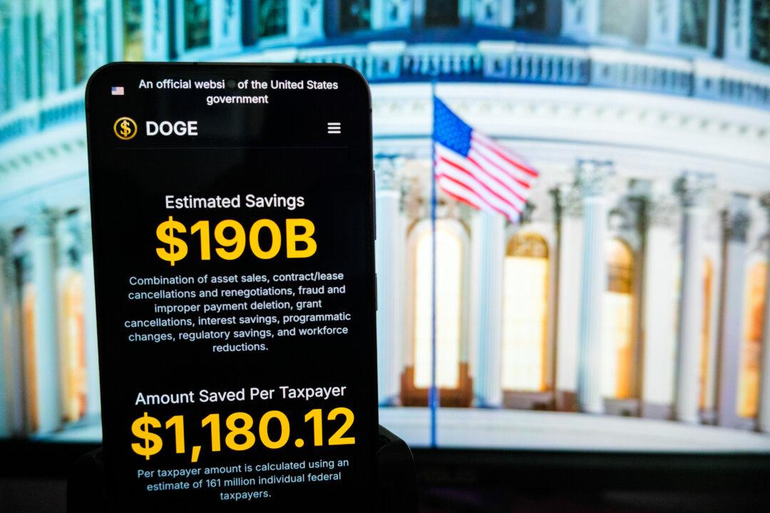 The Department of Government Efficiency (DOGE) website is displayed on a phone, in this photo illustration. (Oleksii Pydsosonnii/The Epoch Times)