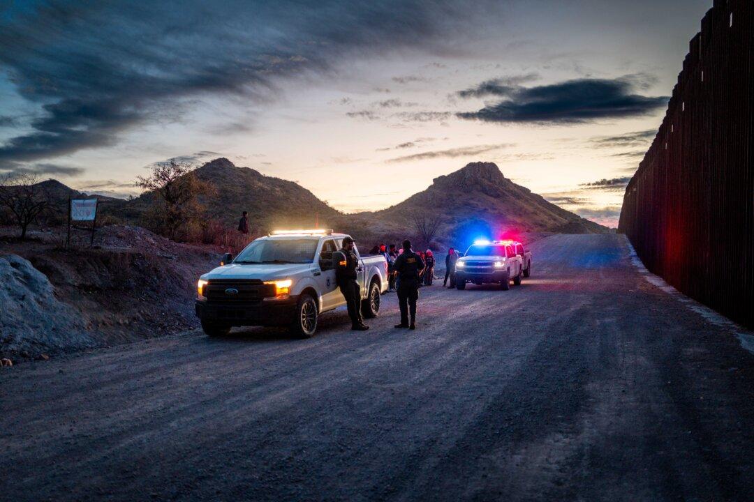 Illegal immigrants from Mexico and Guatemala are apprehended by Border Patrol agents after crossing a section of border wall into Ruby, Ariz., on Jan. 4, 2025. (Brandon Bell/Getty Images)