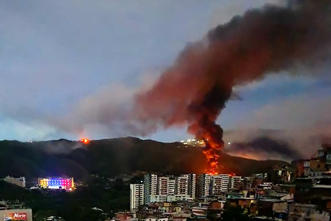 Fire at Fuerte Tiuna, Venezuela's largest military complex, is seen from a distance after a series of explosions in Caracas on Jan. 3, 2026. (AFP via Getty Images)