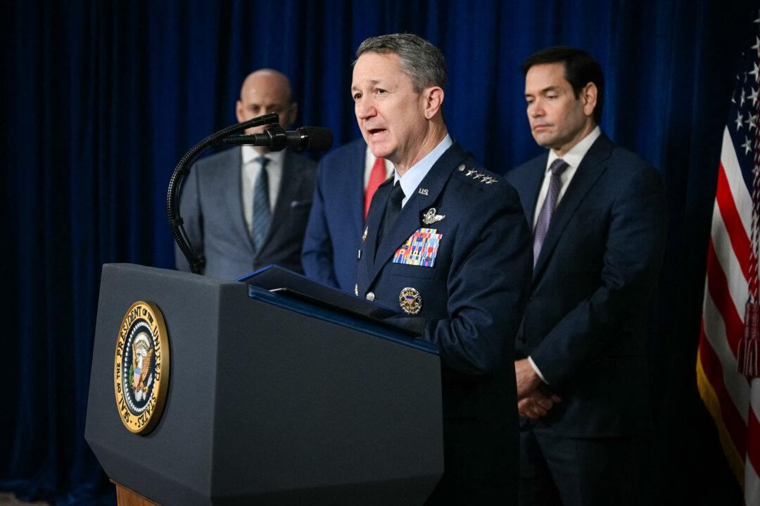 Chairman of the Joint Chiefs of Staff Gen. Dan Caine speaks to the press as Secretary of State Marco Rubio (R) and White House Deputy Chief of Staff Stephen Miller (L) look on, following U.S. military actions in Venezuela, at his Mar-a-Lago residence in Palm Beach, Fla., on Jan. 3, 2026. (Jim Watson/AFP via Getty Images)