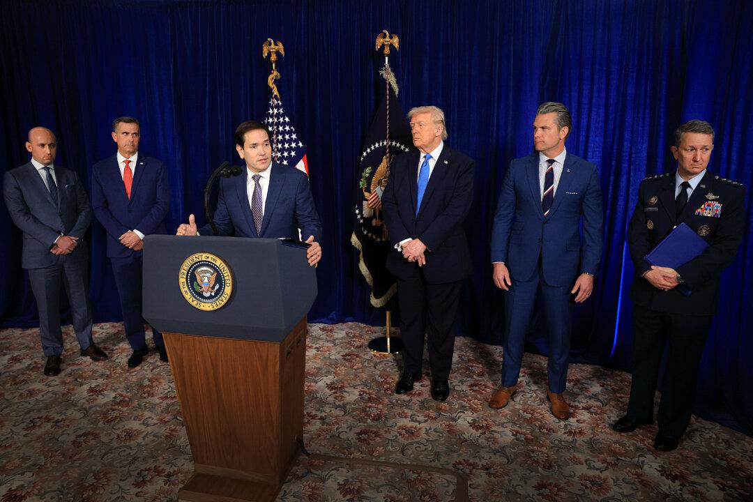 Secretary of State Marco Rubio (3rd L) speaks during a press conference as (L–R) Homeland Security Advisor Stephen Miller, CIA Director John Ratcliffe, President Donald Trump, Secretary of War Pete Hegseth, and Chairman of the Joint Chiefs of Staff Gen. Dan Caine listen at Mar-a-Lago club in Palm Beach, Fla., on Jan. 3, 2026. (Joe Raedle/Getty Images)