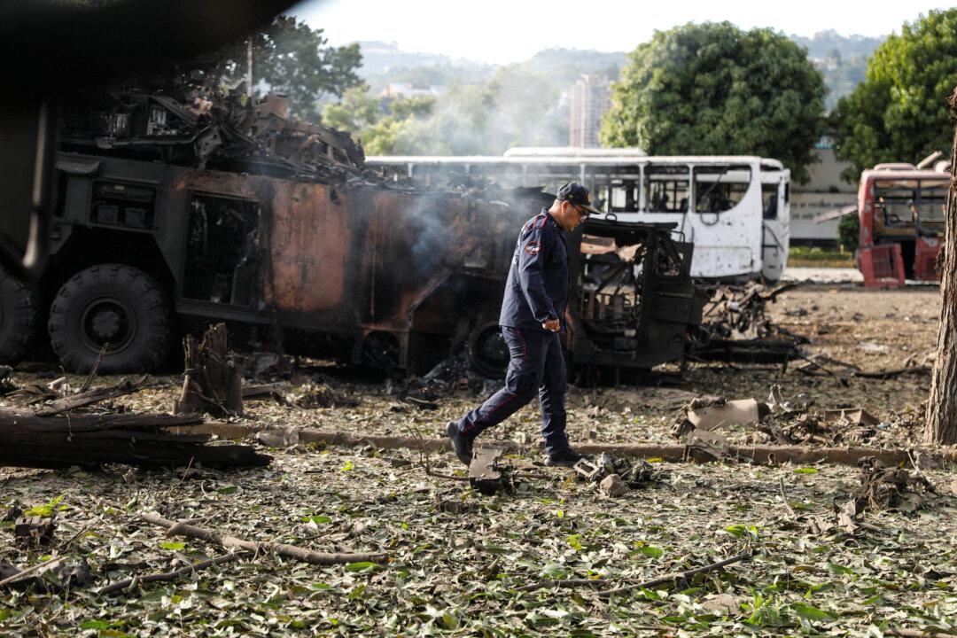 A firefighter walks past a destroyed anti-aircraft unit at La Carlota military air base, after President Donald Trump said the United States had struck Venezuela and captured its leader, Nicolás Maduro, in Caracas, Venezuela, on Jan. 3, 2026. (Leonardo Fernandez Viloria/Reuters)